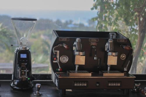 a coffee maker sitting on a counter next to a blender at Peaceful Hill Homestay in Ke Ga