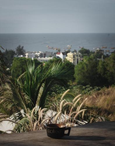 a bench sitting on the side of a road with palm trees at Peaceful Hill Homestay in Ke Ga