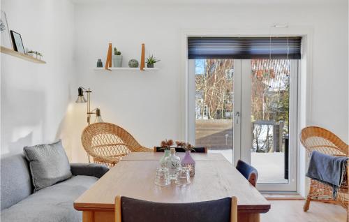a living room with a table and a couch at 3 Bedroom Gorgeous Home In Gudhjem in Gudhjem