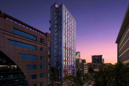 a tall building with a flag on top of it at Moxy Mumbai Andheri West in Mumbai