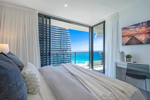 a bedroom with a bed and a view of the ocean at MEGA VIEWS at Oracle - level 32 in Gold Coast