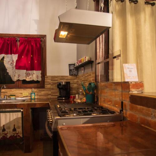 a kitchen with a stove top oven next to a sink at Casa de campo Don Paco in Copan Ruinas