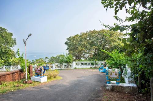 two statues of elephants on the side of a road at Stone Water Eco Resort in Bogmolo
