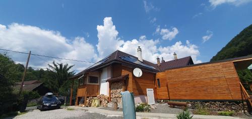 a wooden house with a car parked in front of it at Štiavnička in Mýto pod Ďumbierom