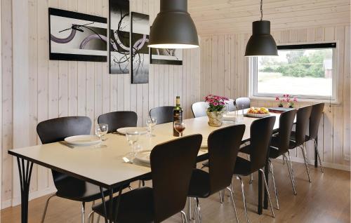 a dining room with a table and chairs at Nice Home In Stege With Sauna in Stege