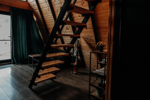 a wooden spiral staircase in a room with a ceiling at Pyramid Home Kazbegi in Stepantsminda