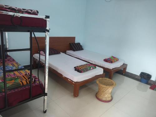 a room with two bunk beds and a shelf at Healing Home And Hostel Auroville in Puducherry