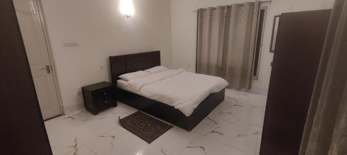Postel nebo postele na pokoji v ubytování Bougainville Rooms