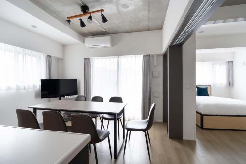 a room with a table and chairs and a bed at ASTILE Oshiage in Tokyo
