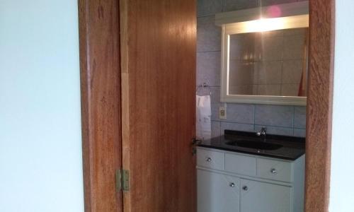 a bathroom with a sink and a mirror at Morada Colibri in Gamboa