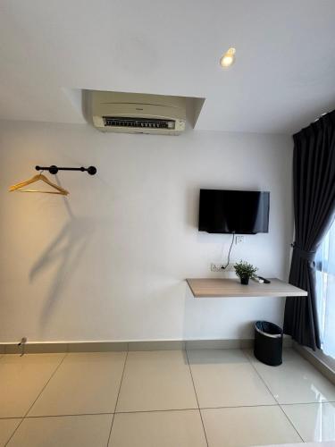 a living room with a tv on a wall at Maca Hotel by Sky Hive in George Town