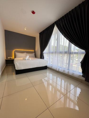 a bedroom with a bed and a large window at Maca Hotel by Sky Hive in George Town