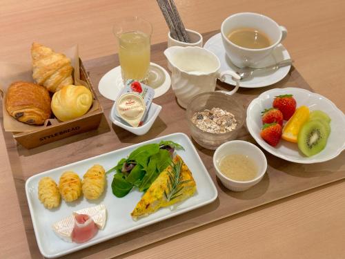 a table with a tray of breakfast foods and drinks at Kyoto Shijo Takakura Hotel Grandereverie in Kyoto