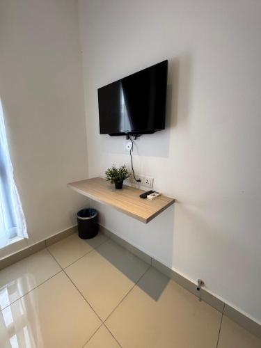 a tv on a wall in a room at Maca Hotel by Sky Hive in George Town