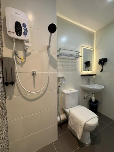 a bathroom with a toilet and a sink at Maca Hotel by Sky Hive in George Town