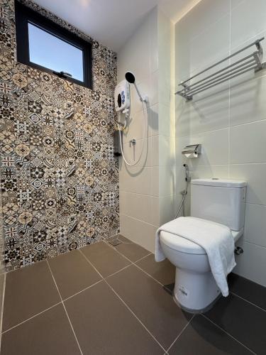 a bathroom with a toilet and a shower at Maca Hotel by Sky Hive in George Town