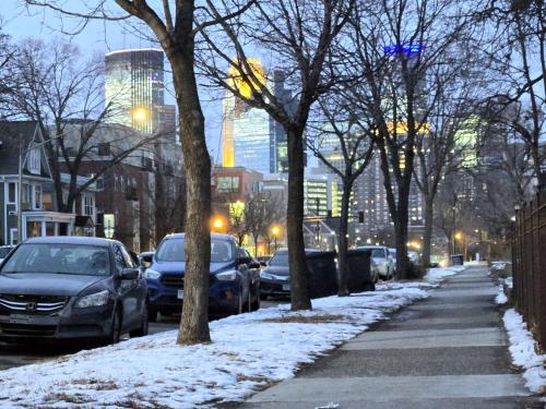 a city street with parked cars in the snow at Ana Maria del Azul in Minneapolis