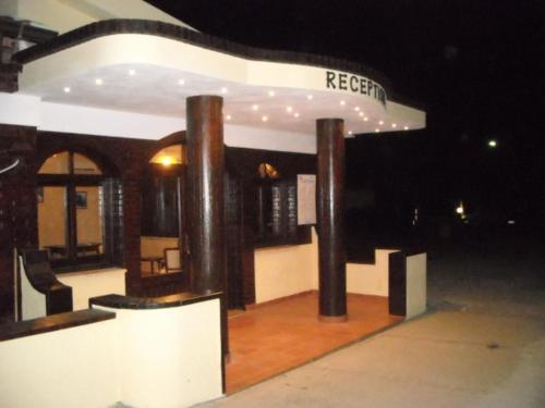 a building with pillars and a room with a reception at Hotel La Fattoria Sul Mare in Capo Vaticano