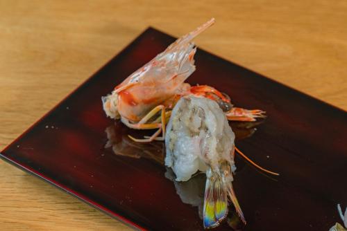 a crab on a black plate on a table at 湯の里いけもり別館 天座 in Himi