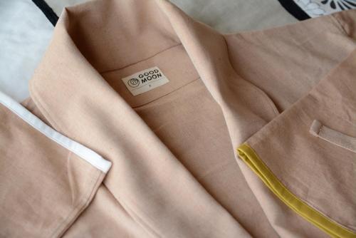 a close up of a brown dress shirt with a yellow zipper at 湯の里いけもり別館 天座 in Himi