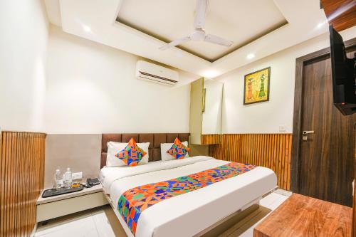 a bedroom with a large bed in a room at FabExpress Shri Sai DX - Nr Adarsh Nagar Metro in New Delhi