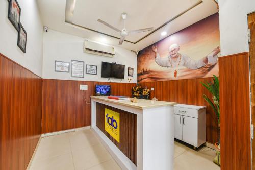 a bar in a room with a painting on the wall at FabExpress Shri Sai DX - Nr Adarsh Nagar Metro in New Delhi
