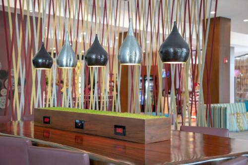 a table with four black vases hanging above it at Residence Inn by Marriott San Jose Escazu in San José