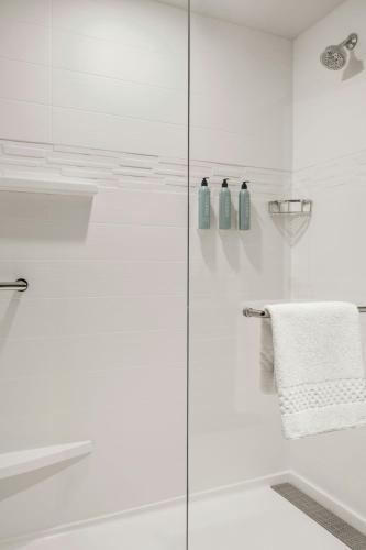a white bathroom with a glass shower door at Residence Inn by Marriott Milwaukee Brookfield at Poplar Creek in Brookfield