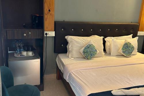 a bedroom with a large bed with white pillows at YogiTree Beach Resort & Cafe - 100m from Morjim Beach in Morjim
