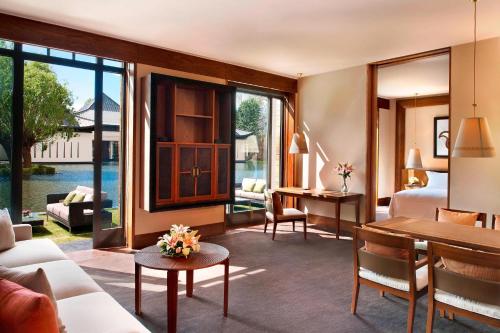 a hotel room with a bedroom and a living room at The St. Regis Lhasa Resort in Lhasa