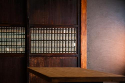a wooden wall with a wooden bench in a room at NATAN - 7mins walk from Kawaguchiko Station in Fujikawaguchiko
