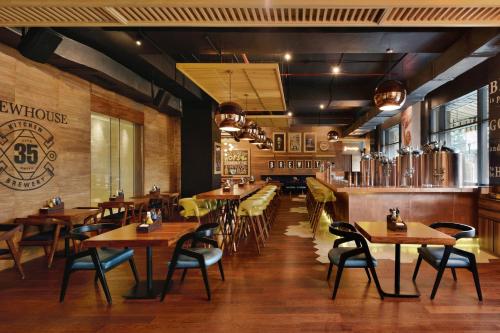 a restaurant with wooden tables and chairs in it at JW Marriott Hotel Chandigarh in Chandīgarh