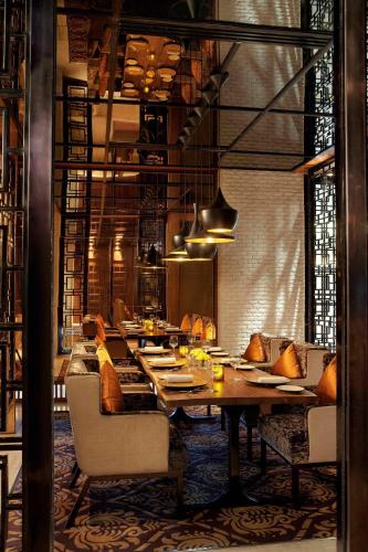 a dining room with a long table and chairs at JW Marriott Hotel Chandigarh in Chandīgarh