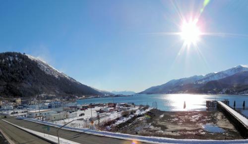 a view of a body of water with the sun in the sky at Ramada by Wyndham Juneau in Juneau