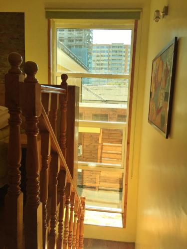 a staircase leading to a window with a view of a building at Tribu Malen Apartamentos in Temuco