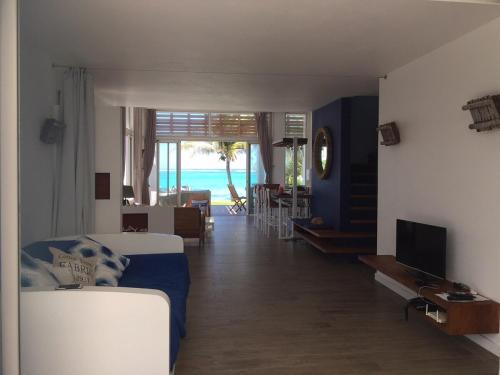 a living room with a view of the ocean at O-Bleu in Pointe d'Esny