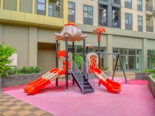 a playground with a slide at Great Location and Comfy 2BR Transpark Cibubur Apartment By Travelio in Depok