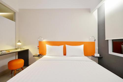 Кровать или кровати в номере TreePark Banjarmasin