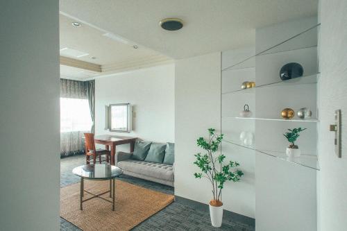 a living room with a couch and a table at Kakegawa Grand Hotel in Kakegawa