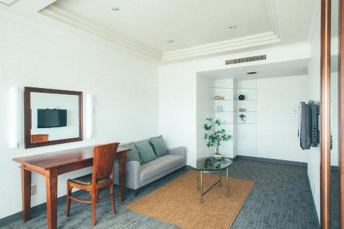 a living room with a table and a couch at Kakegawa Grand Hotel in Kakegawa