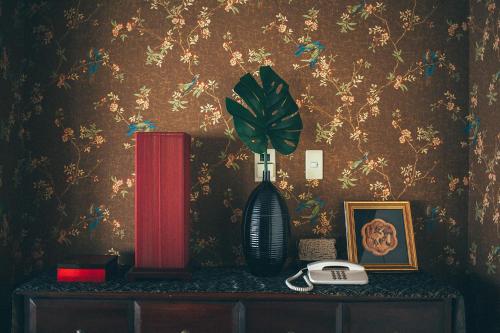 a vase sitting on a table with a plant in it at Kakegawa Grand Hotel in Kakegawa