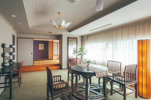 a dining room with a table and chairs at Kakegawa Grand Hotel in Kakegawa