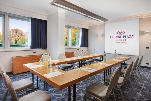 a conference room with long tables and chairs at Crowne Plaza Milan Linate by IHG in San Donato Milanese