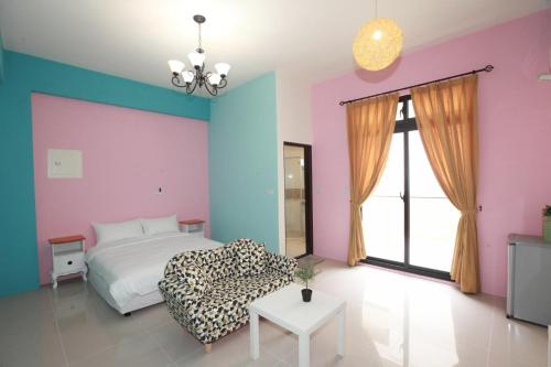 a bedroom with a bed and a couch and a table at This Home B&B in Jian
