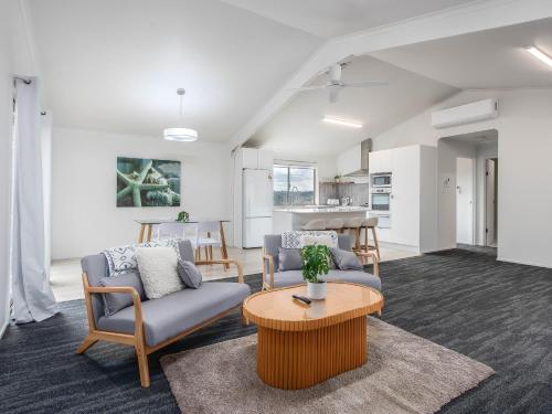a living room with two chairs and a table at THE SHED - Tallebudgera Valley in Tallebudgera