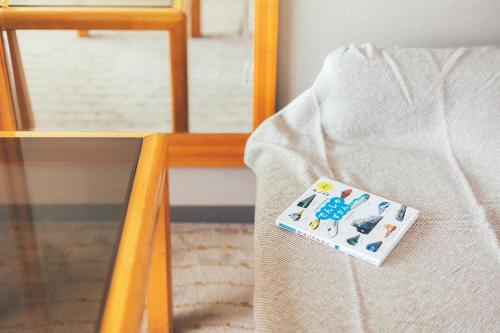 a book sitting on a chair next to a table at Kakegawa Grand Hotel in Kakegawa