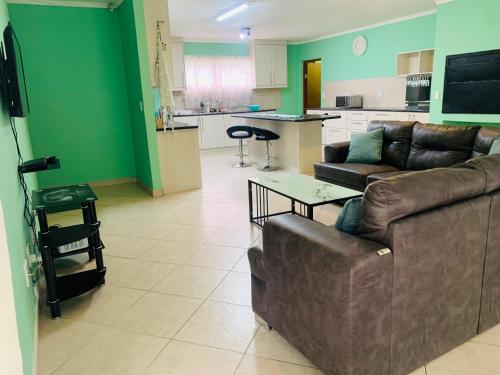 a living room with a couch and a table at The Columbine Holiday Home in Swakopmund