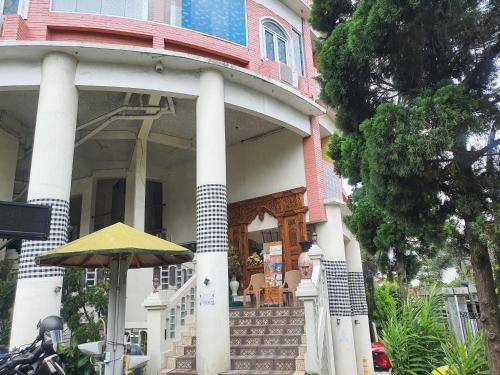 a house with an umbrella in front of it at Java Retro Suites in Bandung