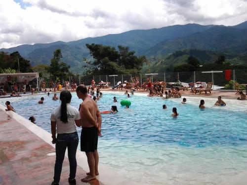 a group of people in a swimming pool at Sky Club Eco Hotel in Belén de Umbría