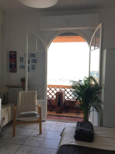 a living room with a bed and a large window at Amazing View Port Golfe-Juan and Garage in Golfe-Juan